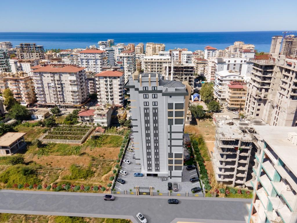 High-rise residential complex with 1+1 and 2+1 apartments in Mahmutlar district - Фото 3